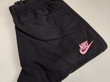 the nike shorts are black and pink with a pink nike logo on the side