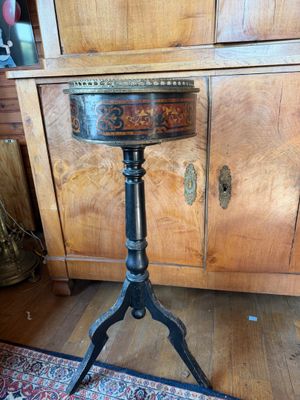 a small table with a stool on it in a room