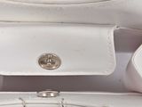 a white purse with a chain hanging from it