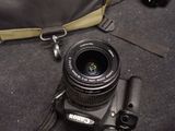 a camera with a lens attached to it on the ground