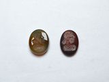 two pieces of stone with a picture of a man and a woman on them