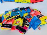 a pile of assorted clothing on a white surface