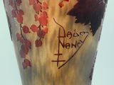 a glass vase with a painting of a bird on it