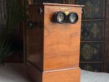 a small wooden box with a pair of binoculars on it