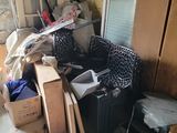 a room with a lot of clutter and boxes on the floor
