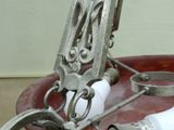 a red bowl with a pair of scissors in it