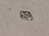 a frog that is sitting in the middle of a hole