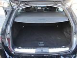 the back of a car with its trunk open on the side of the road