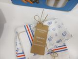 three napkins with a tag on them sitting on a counter