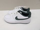 white and green nike air force sneakers on a white surface
