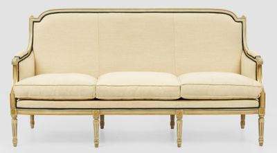 a white couch with a beige upholstered back and arms
