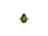a close up of a ring with a green stone in it