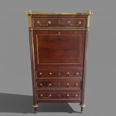 an antique chest of drawers with brass hardware and a marble top