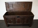 an old wooden chest sitting on top of a carpeted floor