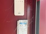 an image of a red door with a phone and a spider web