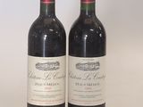 two bottles of wine sitting next to each other on a table