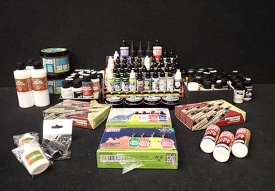 de nombreux types de peinture et de matériel sur la table