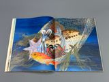 an open book with a picture of a fish in a net
