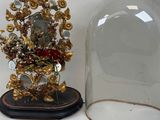 a glass bellow with a clock inside of it on a table