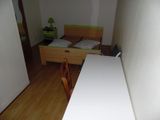 a bed and a desk in a small room