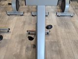 a row of stationary exercise bikes in a gym