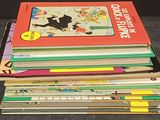 a stack of children ' s books sitting on a table