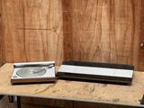 a record player sitting on top of a table next to a record player
