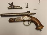 a close up of a gun and other items on a table