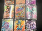 a bunch of pokemon cards are sitting on a table