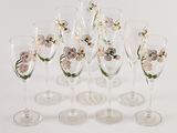 six wine glasses with flowers on them sitting on a white surface