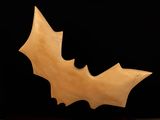 wooden bat sculpture on a black background with a black background