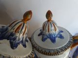 two blue and white vases sitting on top of a table