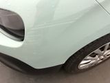 a close up of a car ' s front bumper with water droplets on it