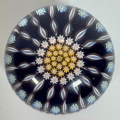 a black and white plate with a flower design on it