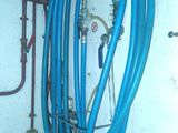 a blue hose that is attached to a wall