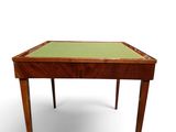 an image of a small wooden table with a green top