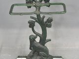 a statue of a monkey sitting on top of a tree