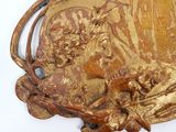 a gold plate with a picture of a woman and a cat