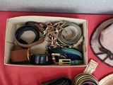 a box filled with hats, belts, and other items
