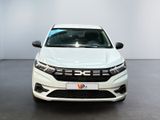 the front view of a white car parked in a showroom
