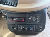 a car dashboard with a radio and other electronic controls