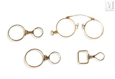 four pairs of eyeglasses and a ring on a white background