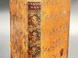 an old book sitting on top of a table next to a black table
