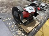 a machine that is sitting on top of a piece of wood