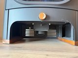 a close up view of a small stove on a wooden table