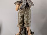 statue of a boy with a bird on his shoulder