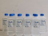 several bottles of water are lined up on a shelf