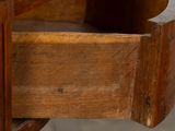 a close up of a wooden table with a drawer underneath it