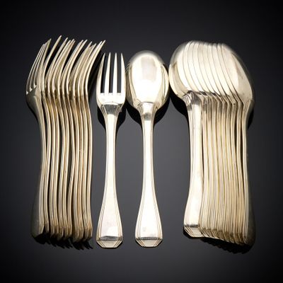 a lot of forks and spoons sitting on a table