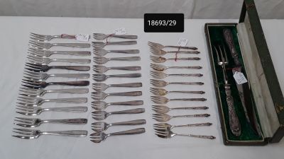 many forks and spoons in a case on a table